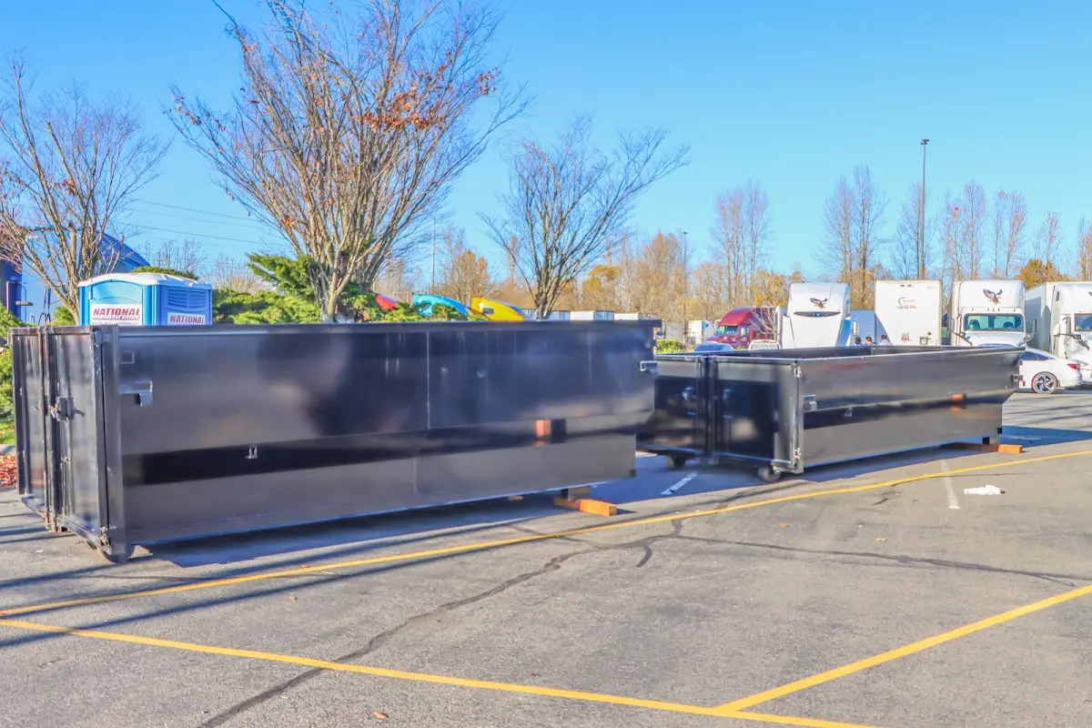 Professional dumpster rental service with roll-off container on residential driveway in Willoughby